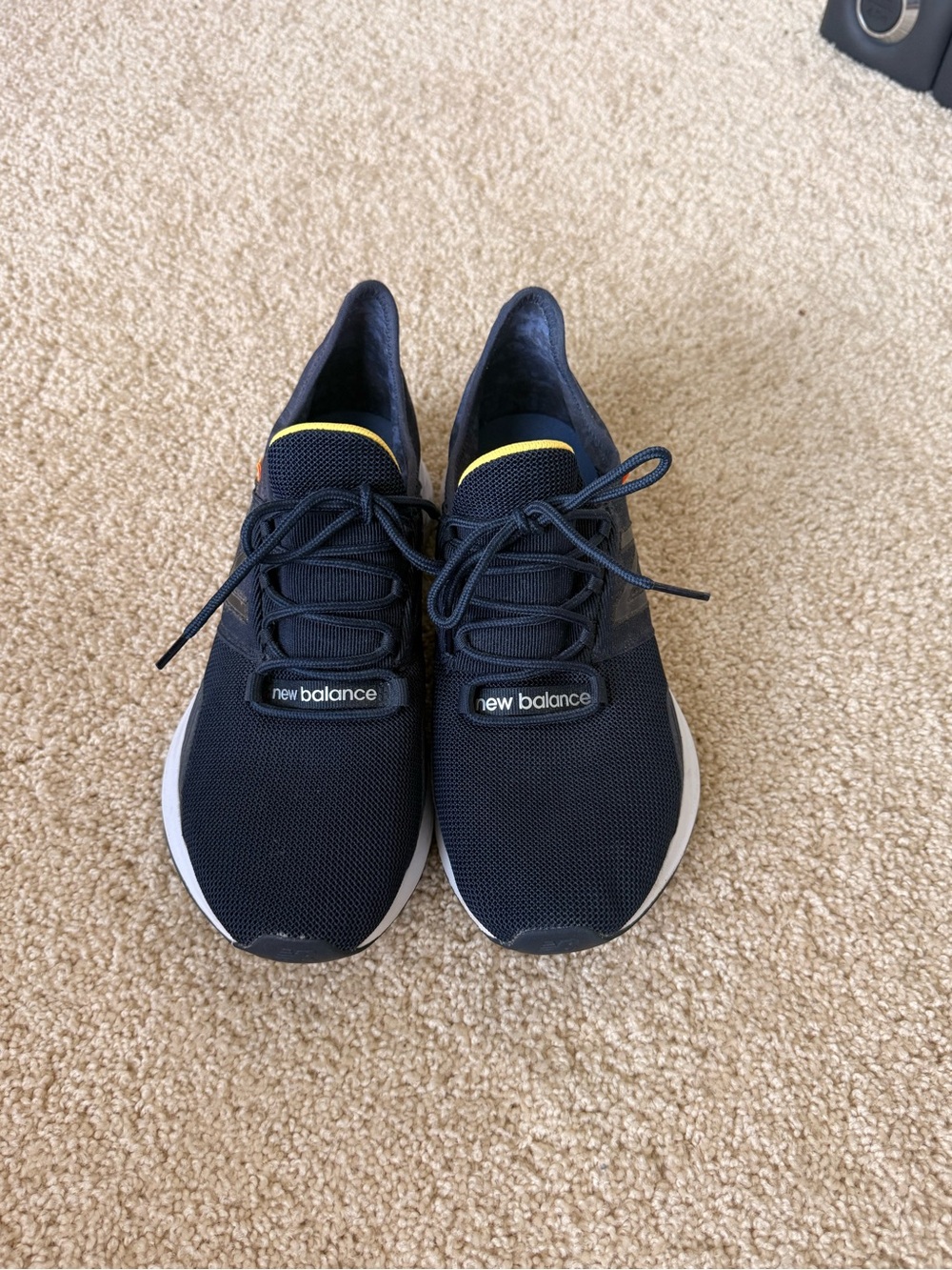 New Balance Woman’s Navy Athletic Sneakers with Yellow Accent